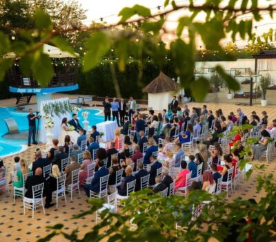 Nuntă în aer liber la Aqua Es Mar cu o piscină și mulți invitați.