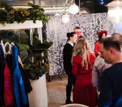 Oameni care stau în picioare la un eveniment cu decoruri cu sclipici și umbrele de lumină.